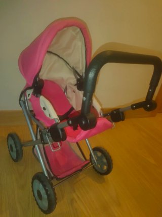 Carrito de bebé de juguete rosa