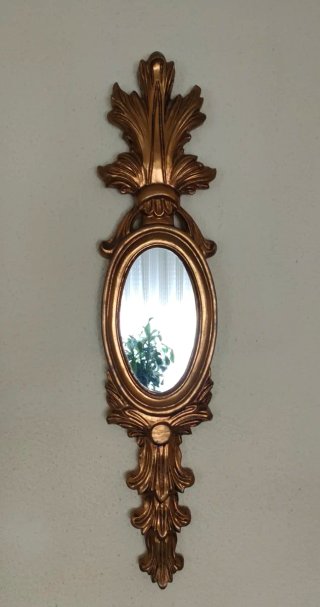 Espejo decorativo dorado ovalado