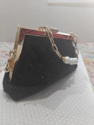 Bolso negro elegante con cadena de oro y perlas