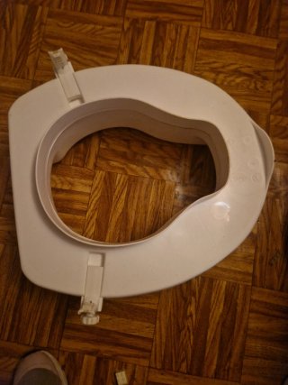 Asiento elevador para WC
