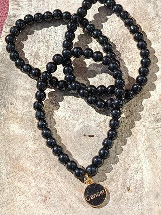 Pulsera mineral Onix con colgante de horiscopo