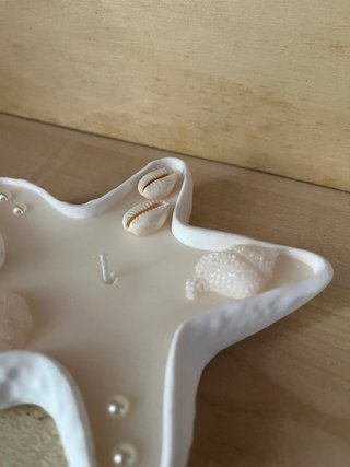 Candela a forma di stella marina con conchiglie