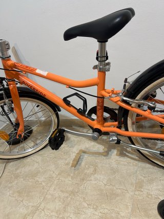 Bicicleta naranja RIVERSIDE sin usar