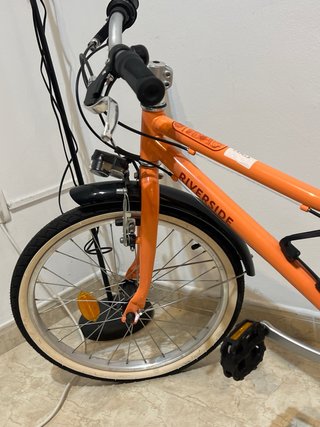 Bicicleta naranja RIVERSIDE sin usar