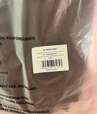Pantalón Gymshark Marrón con Raya Rosa