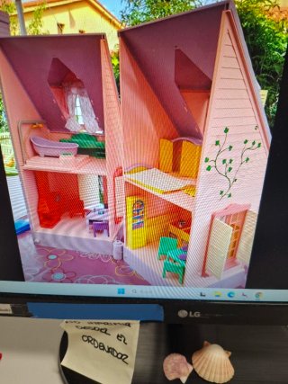 Casa de muñecas rosa con ventana y chimenea