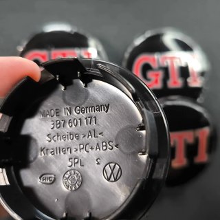 TAPABUJES VW GTI 65mm NEGROS - EMBLEMA VOLKSWAGEN