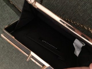 Bolso de fiesta negro con detalles dorados.