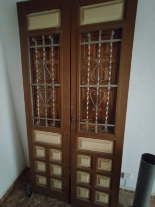 Puerta doble de madera con rejas