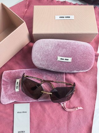 Gafas de sol Miu Miu marrones y doradas