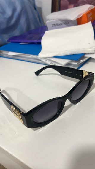 Gafas de sol Miu Miu negras y doradas