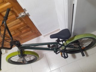 Bicicleta BMX verde con ruedas llamativas