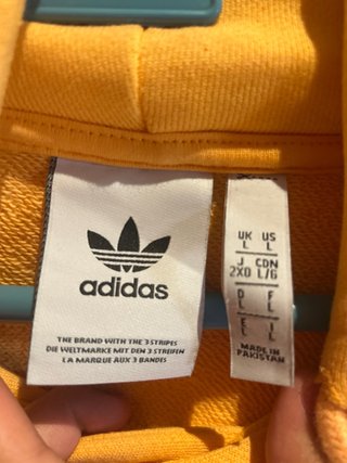Sudadera Adidas naranja con logo lila