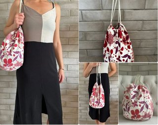 Bolso blanco tipo saco con estampado de flores.