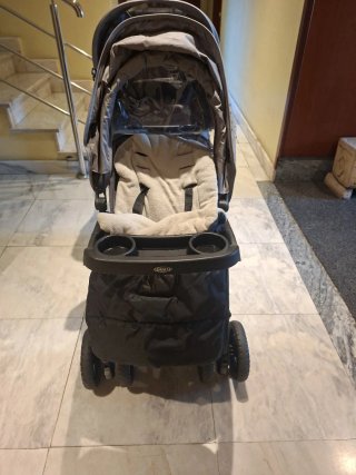 Carrito gemelar con funda impermeable