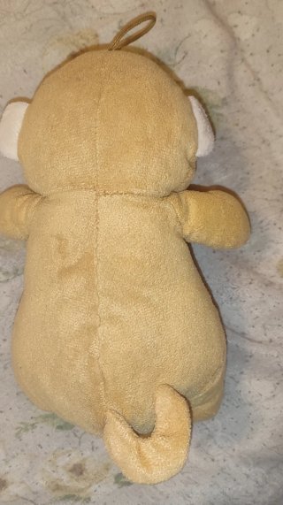 Peluche scimmietta gialla con fiocco