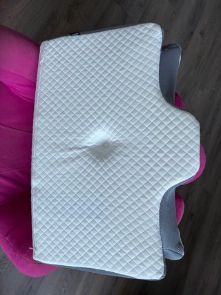 Almohada cervical gris y blanca
