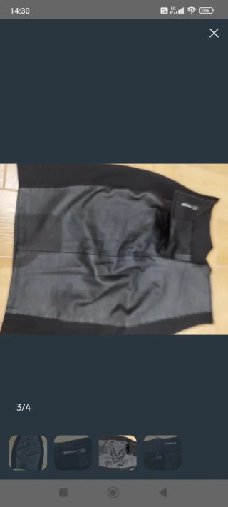 Falda y abrigo negro con mangas de cuero