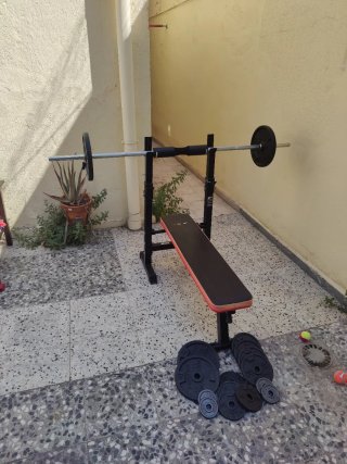 Banco musculación + Barra olímpica + Discos