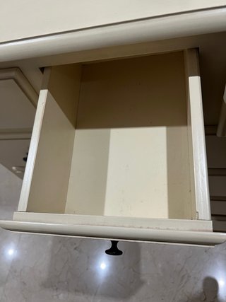 Cómoda de madera beige con cajones.