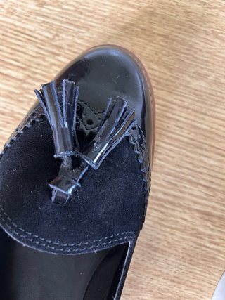 Zapatos planos negros con flecos