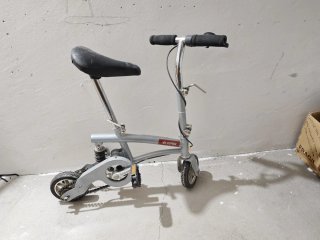 Minibike plegable de color gris.