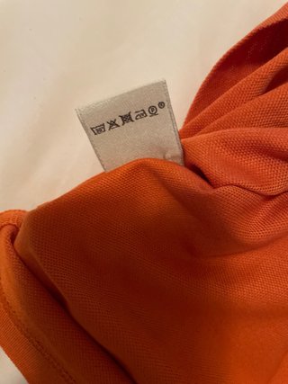 Polo Hermes arancione con taschino