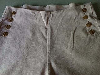 Pantalones/leggins rosas con botones dorados