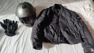 Chaqueta de moto negra y casco.