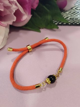 Braccialetto arancio con su Coccu nero