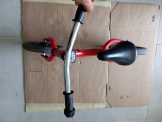 Bicicleta infantil roja sin pedales.