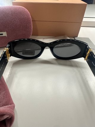 Gafas de sol Miu Miu Negras y Doradas Mujer