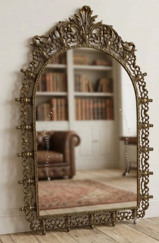 Espejo de bronce con marco ornamentado