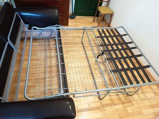 Sofá cama Suinta en tela y cuero