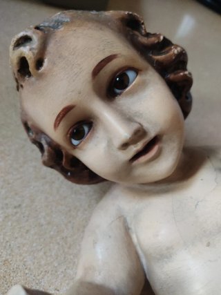 Niño Jesús vintage en cuna de ramas