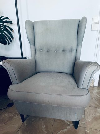 Butaca estilo orejero gris claro.