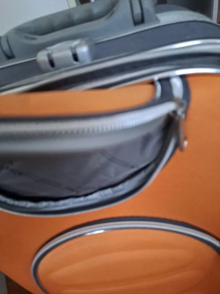 Maleta de viaje naranja y gris con ruedas