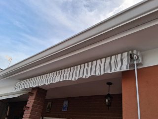 Toldo extensible gris y blanco