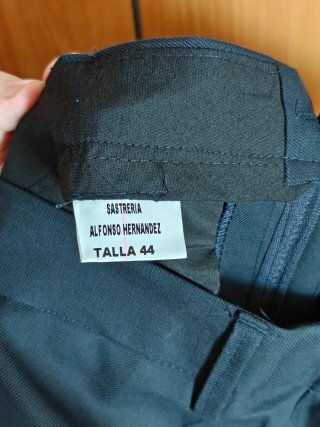 Traje azul marino con etiqueta y corbata amarilla