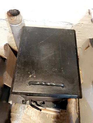 Estufa de leña con horno metálica negra.
