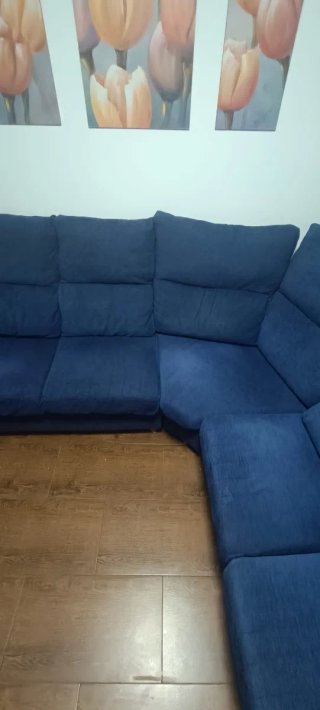 Sofá esquinero azul de tela.