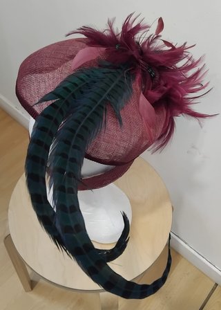 Tocado de invitada burdeos con plumas