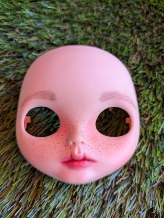 Cara Blythe con pecas y labios pintados