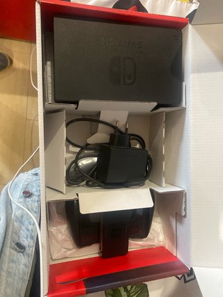 Nintendo Switch Rojo, Azul y Naranja en su caja.