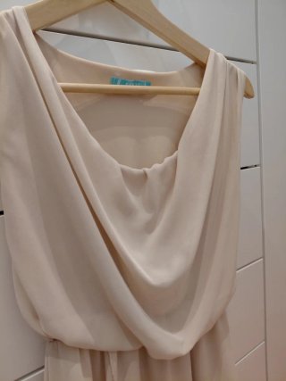 Vestido cóctel drapeado beige.