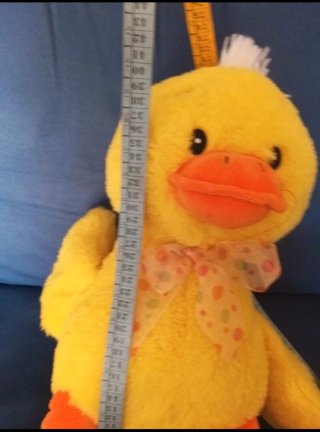 Peluche anatra gialla con fiocco