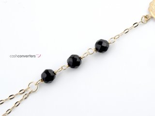 manita oro 18k con piedra con onix