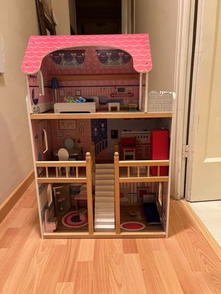 Casa de muñecas rosa con muebles