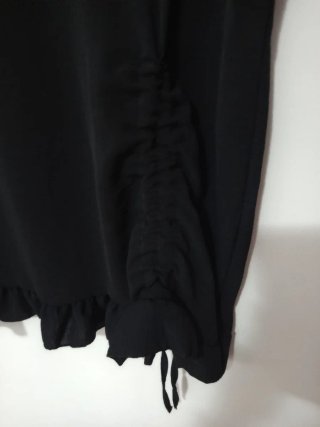 Blusa negra con fruncido y volantes