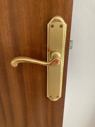 Puerta de madera con manilla dorada